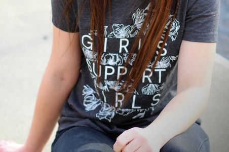 Girl sitting wearing printed t shirt