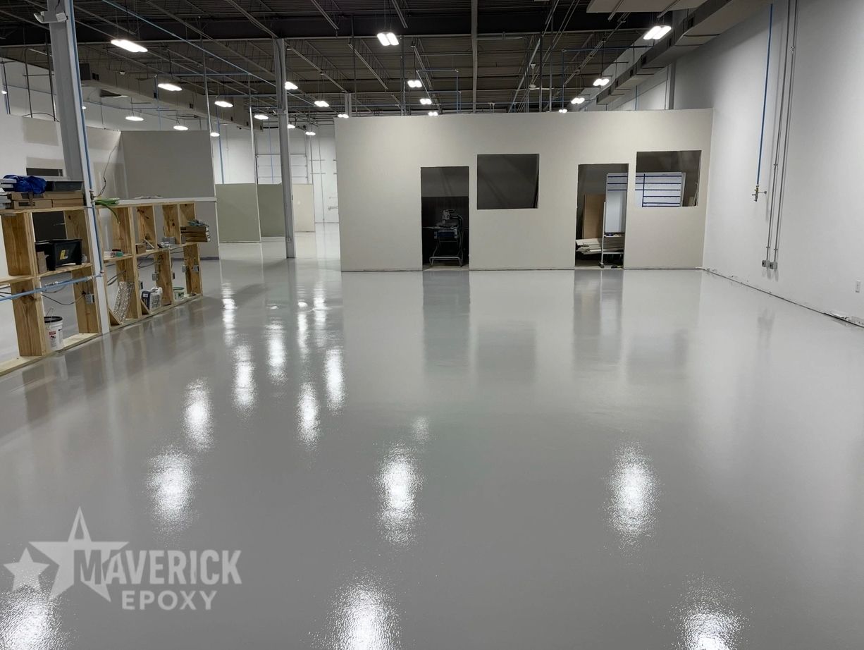Shiny epoxy-coated floor in a spacious industrial warehouse.