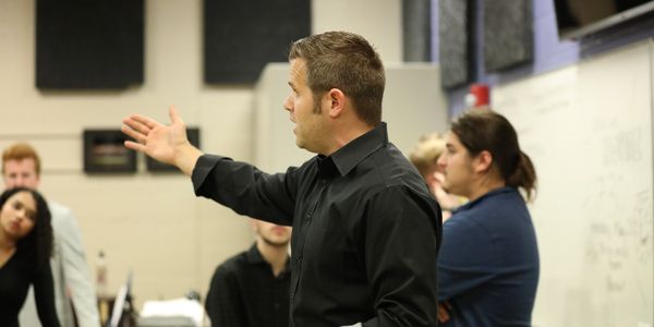 Education will always be our core focus. Pictured, Mr Scott instructs the group before performance.