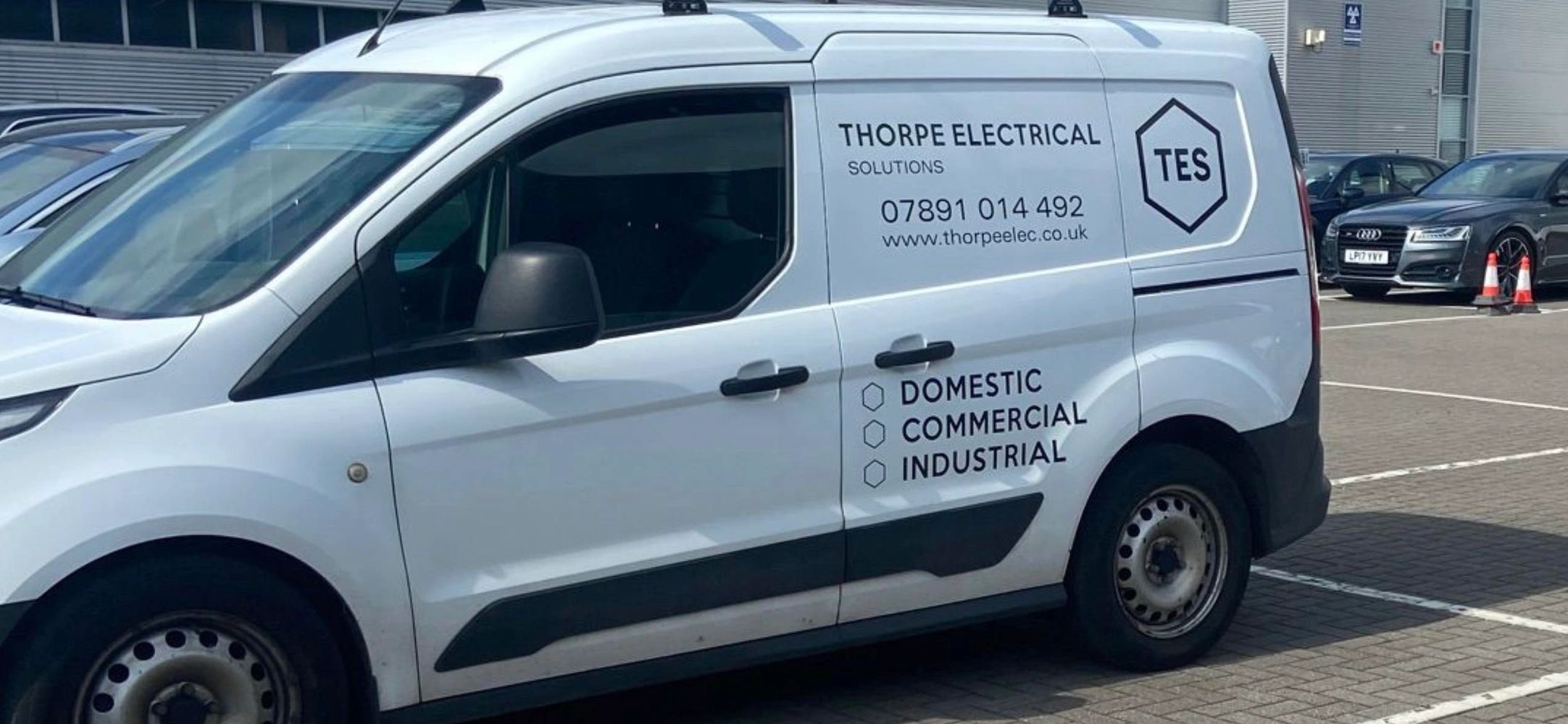 Side angle view of a van showing the Thorpe Electrical Solutions logo. 