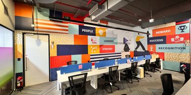 Modern office with colorful motivational wall art and ergonomic chairs.