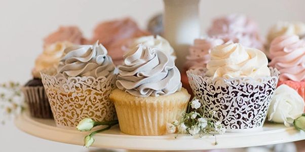 Cupcake wraps are a beautiful addition to cupcake towers.  Flowers add interest to this design.