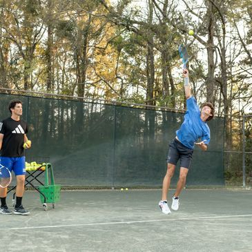 Tennis club pro / owner giving tennis lessons.