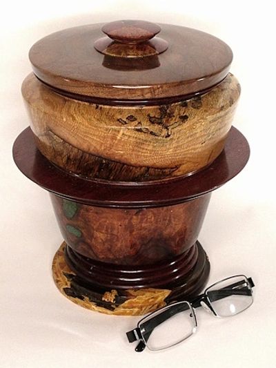 This large urn is made with domestic and exotic wood types, including inlayed turquoise stones.
