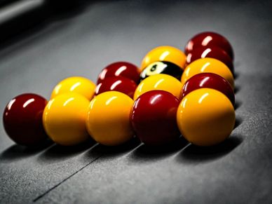 Set of billiard balls arranged in a triangle.
