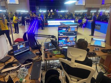 Professional snooker event with live streaming setup and players.