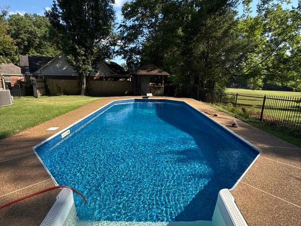 Clear blue backyard swimming pool on a sunny day.