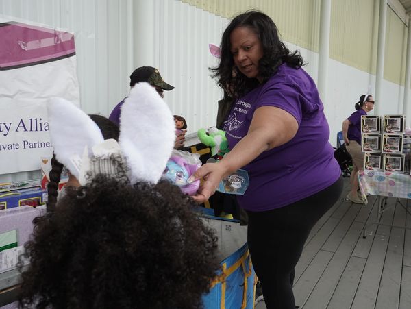 Angela handing out gifts to children