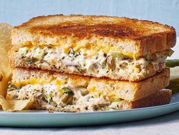 Grilled sandwich filled with creamy chicken salad and herbs.