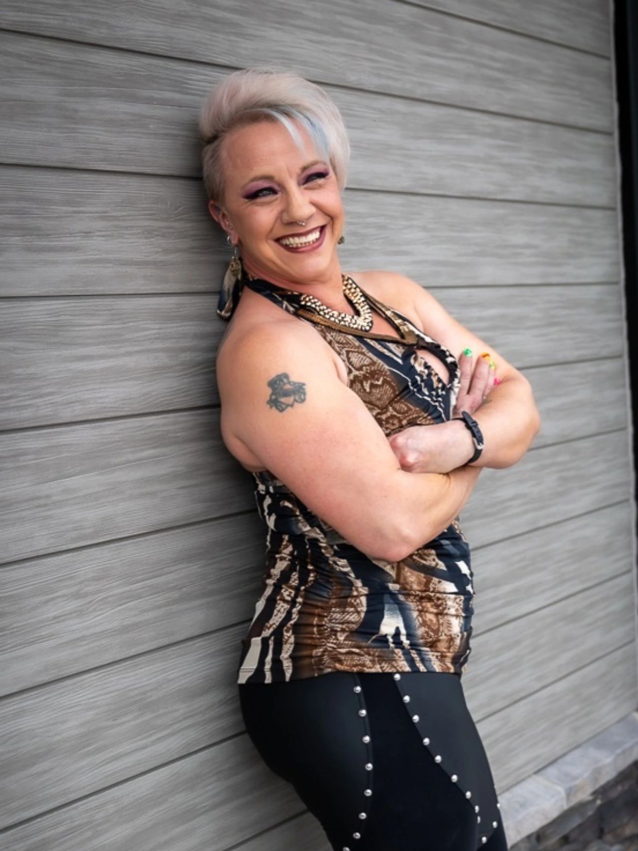 Edgy stylist in animal print top and faux leather pants