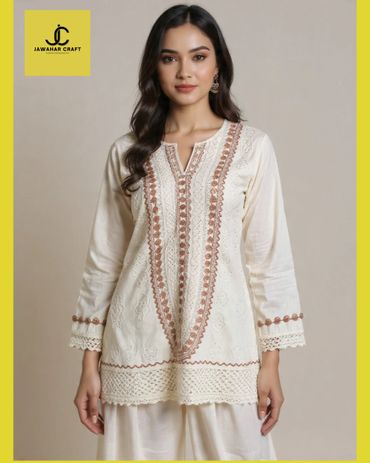 Woman wearing an elegant cream embroidered kurta with full sleeves.