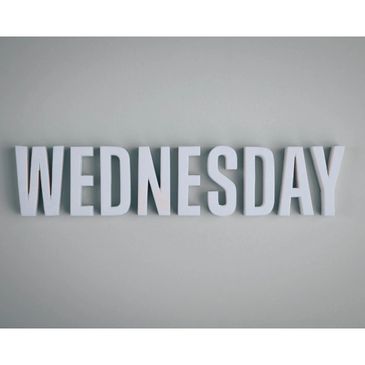 White block letters spelling Wednesday on a gray background.