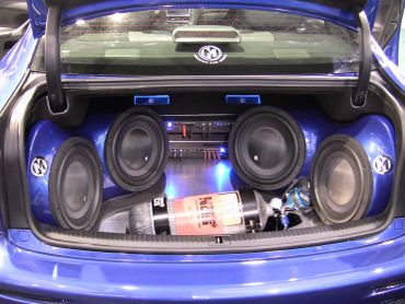 Car trunk with high-powered sound system and fire extinguisher.