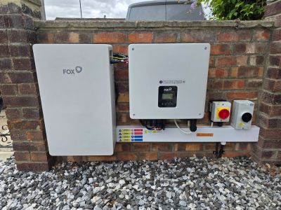 Electrical equipment mounted on a brick wall outdoors.