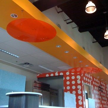 Modern interior with orange accents and polka dot patterns.