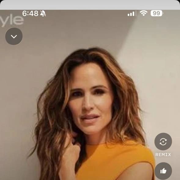Jennifer Garner posing in a stylish yellow outfit for InStyle.