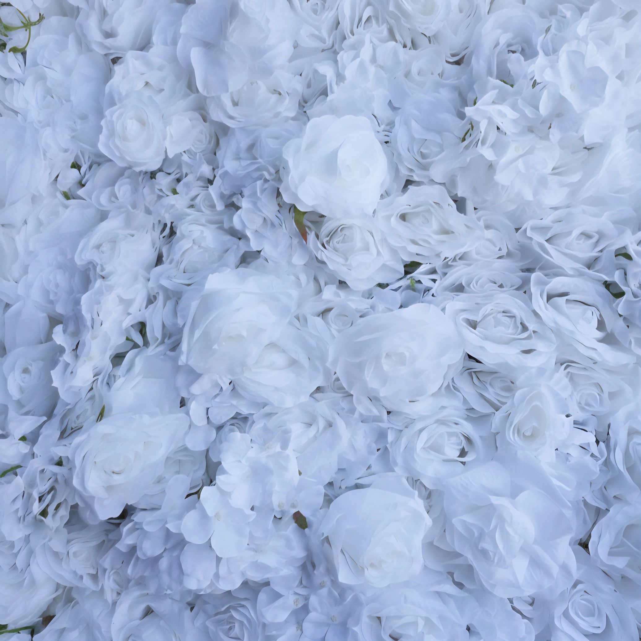 Close-up of a dense cluster of white artificial roses.