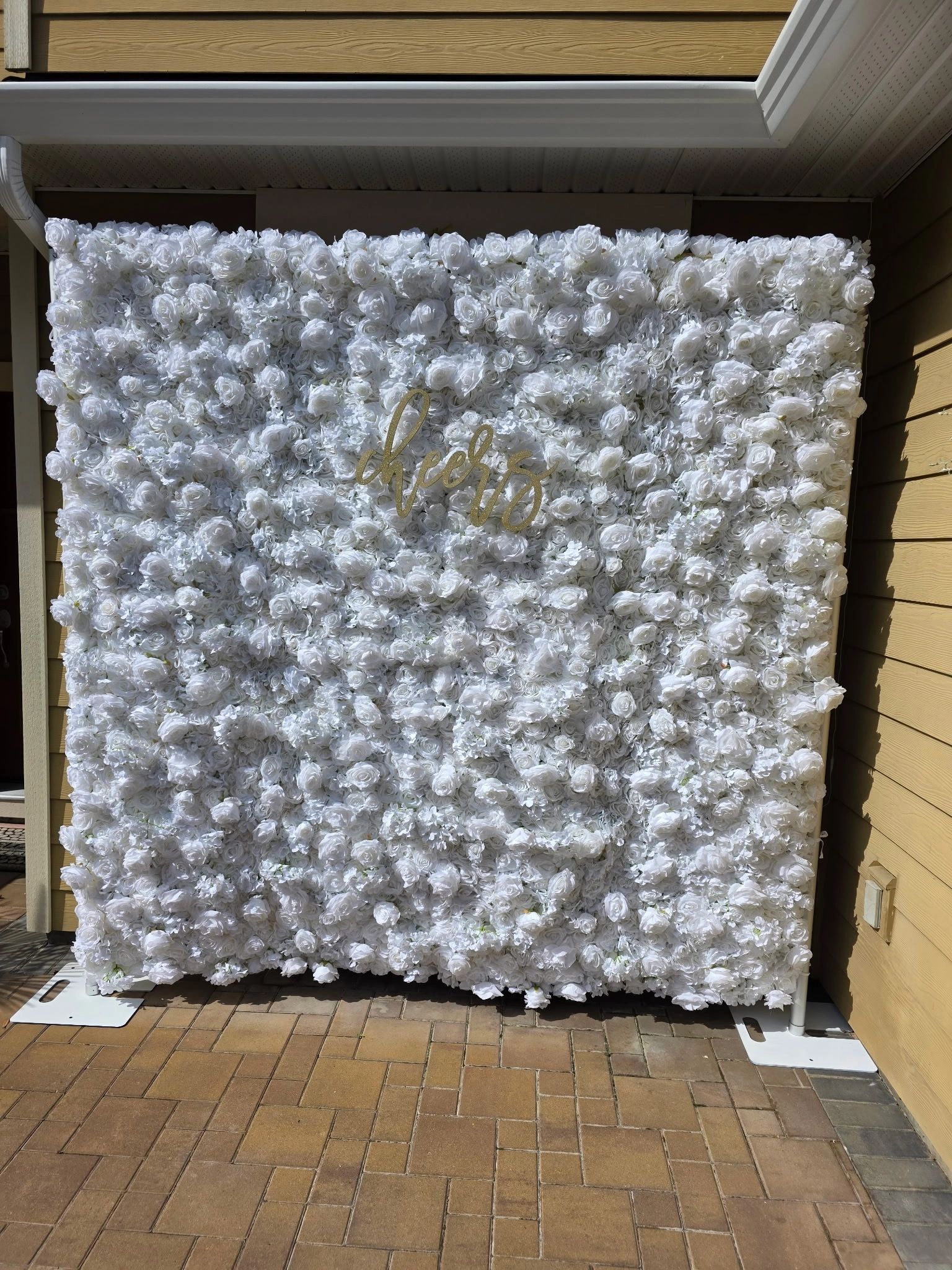 White floral backdrop with the word 'cheers' in gold script.