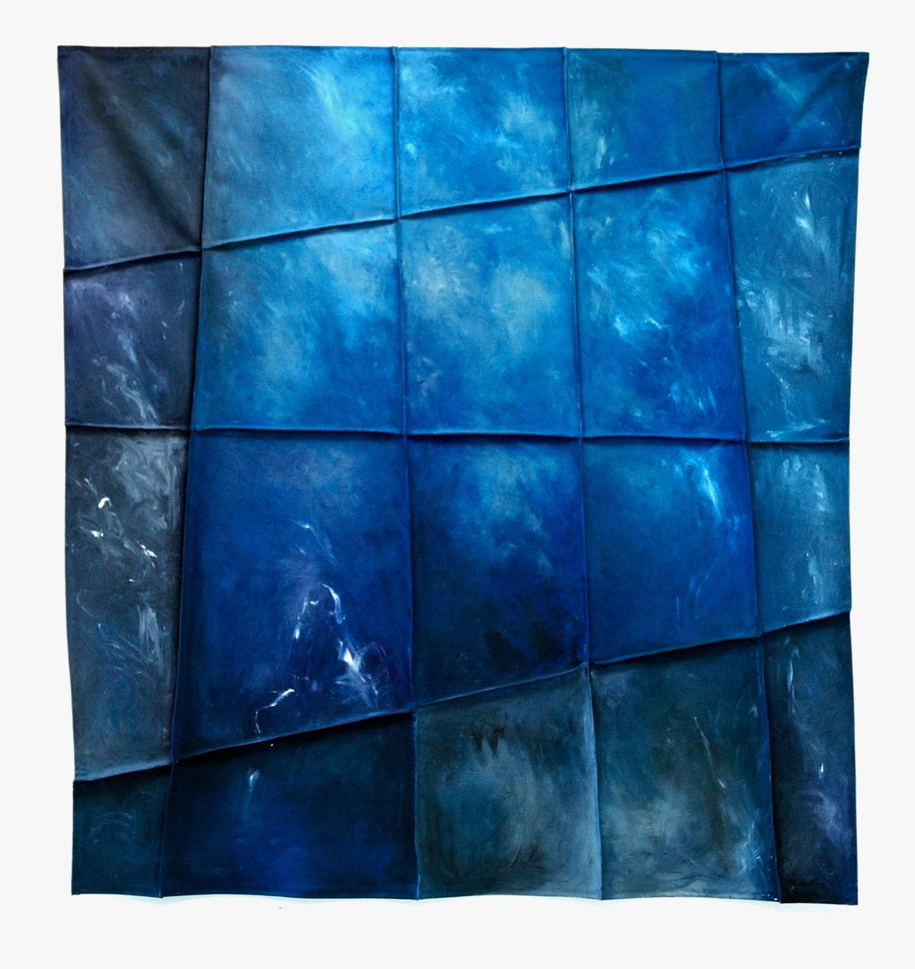 Abstract blue textured artwork with folded, grid-like pattern.