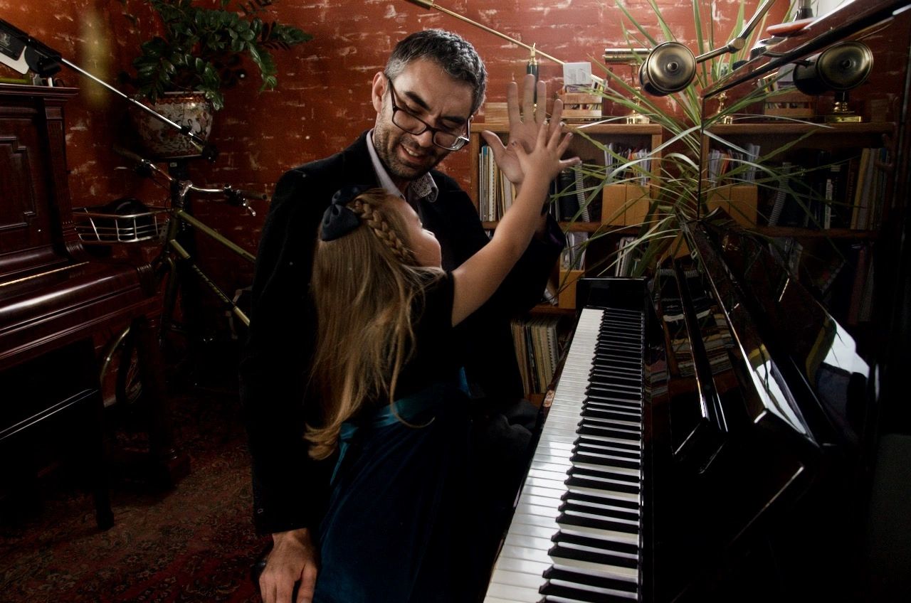 Mr Josh playing piano with a young student at his studio in Colorado Springs