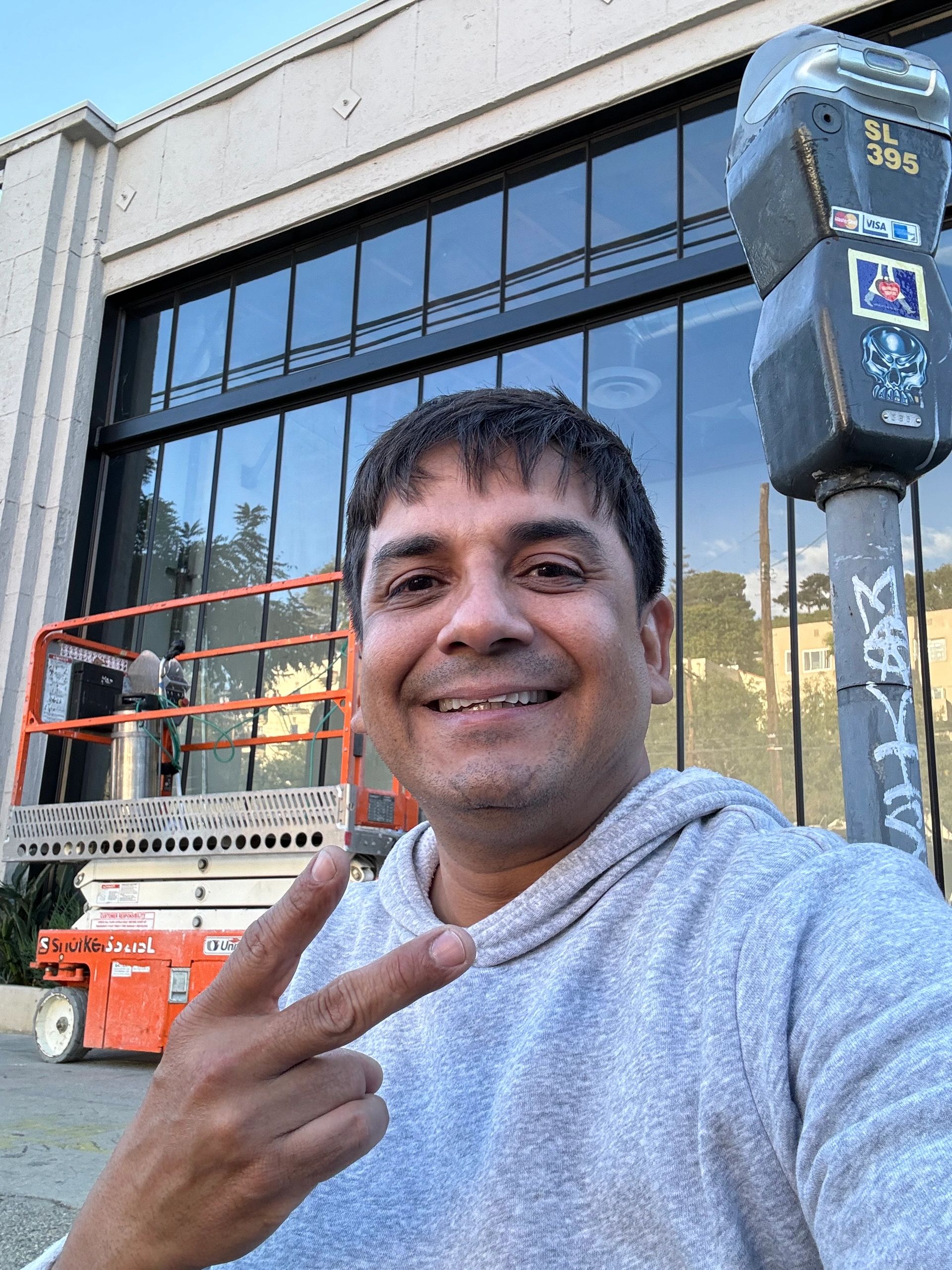 Felipe Jimenez, VisionGuard owner, at a storefront after anti-graffiti film install.