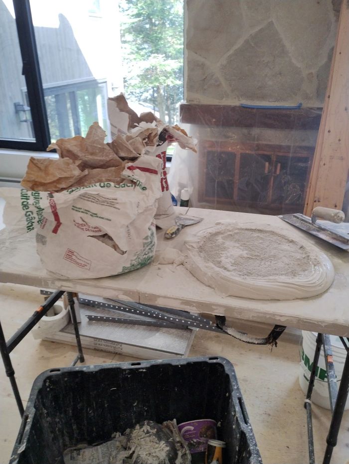 Work table with plastering materials in a construction area.