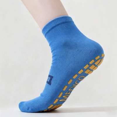 Blue sock with yellow anti-slip grips on sole.