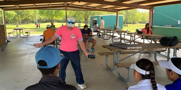 PGA Pro teaching a mobile clinic to kids.