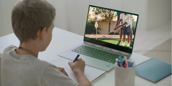 A boy taking an online Fore-The-Youth golf class.