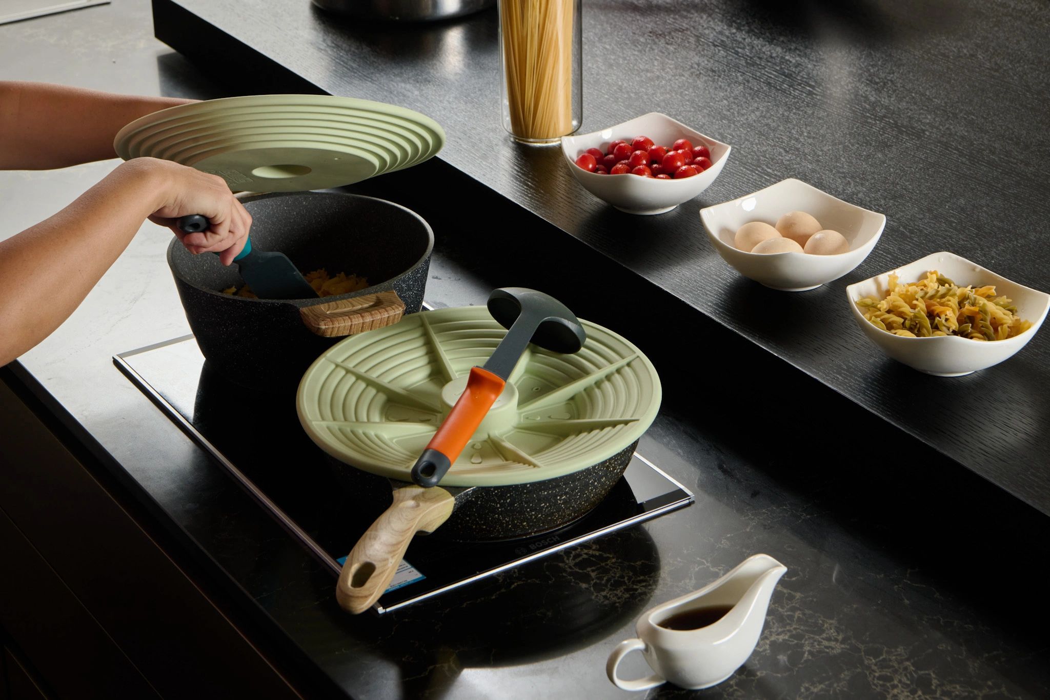 cooking using Alo Aida universal lid, in a modern kitchen, cooking soup and stew while boiling pasta.