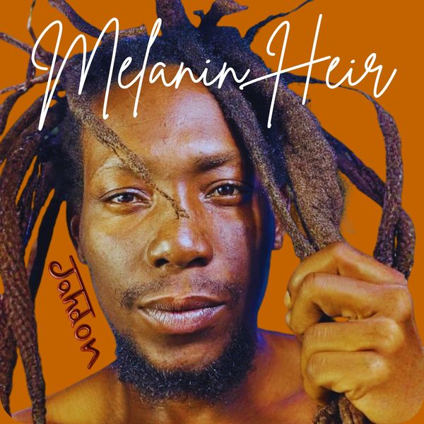 Close-up portrait of a man with dreadlocks against an orange background.