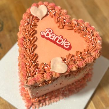 Barbie-themed heart-shaped cake—perfect for birthday parties with a fun, stylish, pink design!