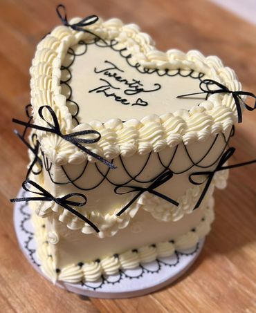 Elegant white heart-shaped cake with striking black accents