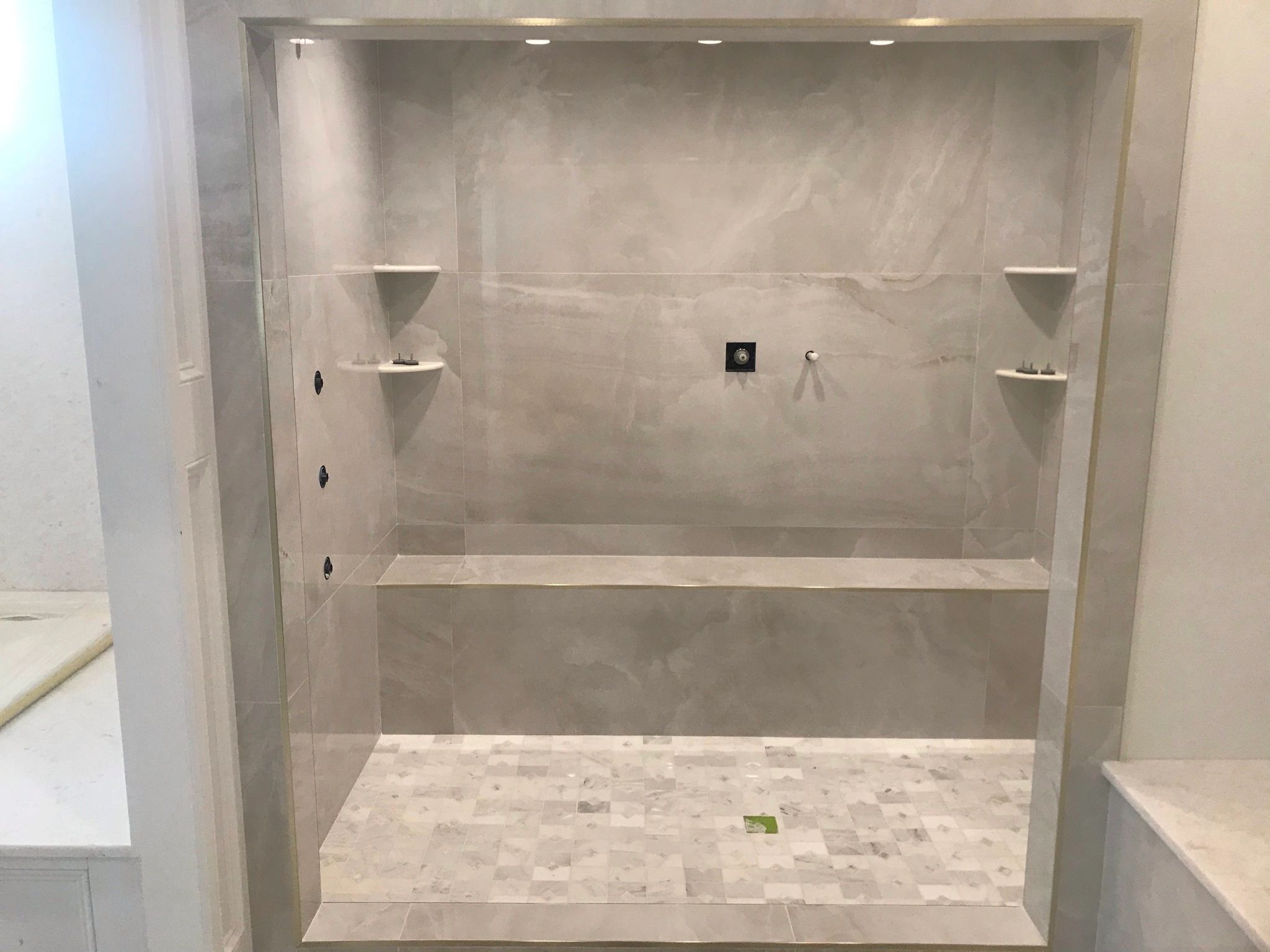 Modern tiled shower area under construction.