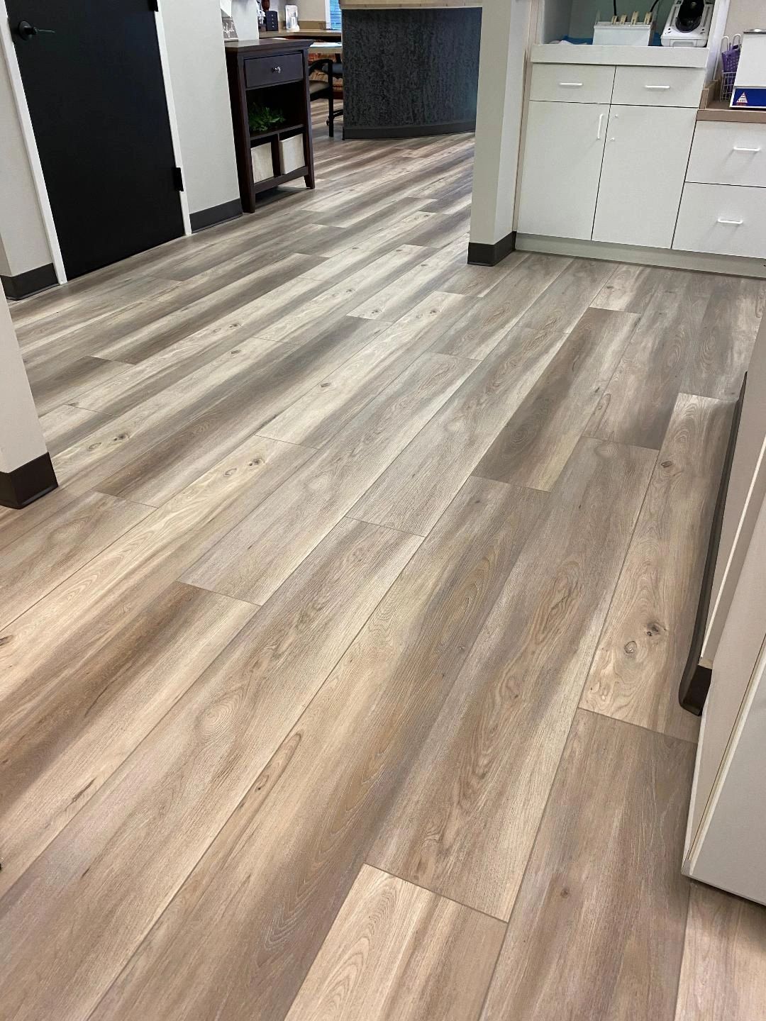 Modern indoor space with light wood flooring.