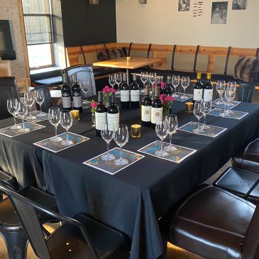 Elegant wine tasting setup with multiple wine bottles and glasses.