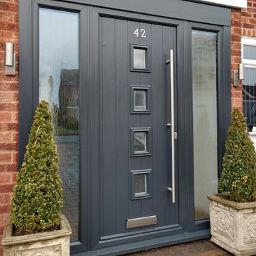 Anthracite Grey composite front door with matching frame and side panels with a Long Bar handle.
