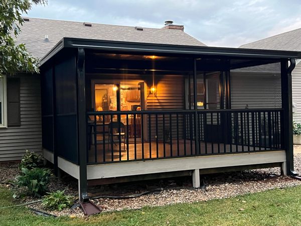 Bronze Aluminum flat pan deck cover, with screen enclosure. This room has aluminum spindles 