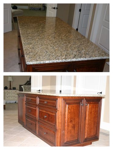 Granite countertop on cherry bathroom island with drawers and cabinets.