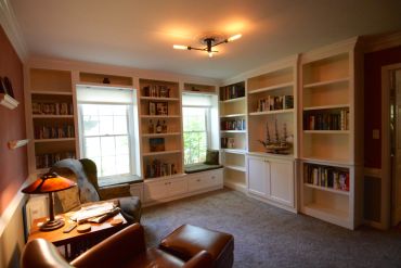Cozy reading nook with bookshelves and natural light.