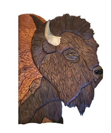 Wooden artwork of profile of a bison.   Slightly 3-D, made from varieties of wood.
No paint or stain