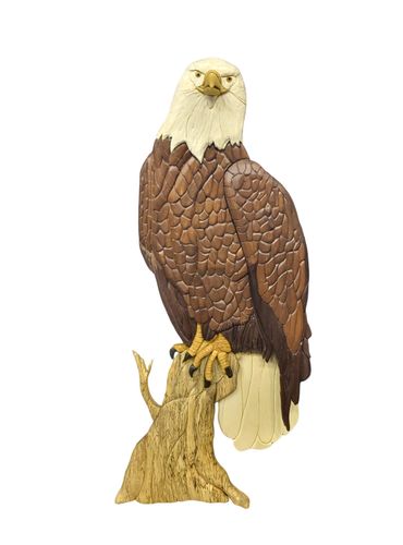 Wooden artwork of a Bald Eagle perched on a branch, looking forward.  Slightly 3-D, no paint/stain