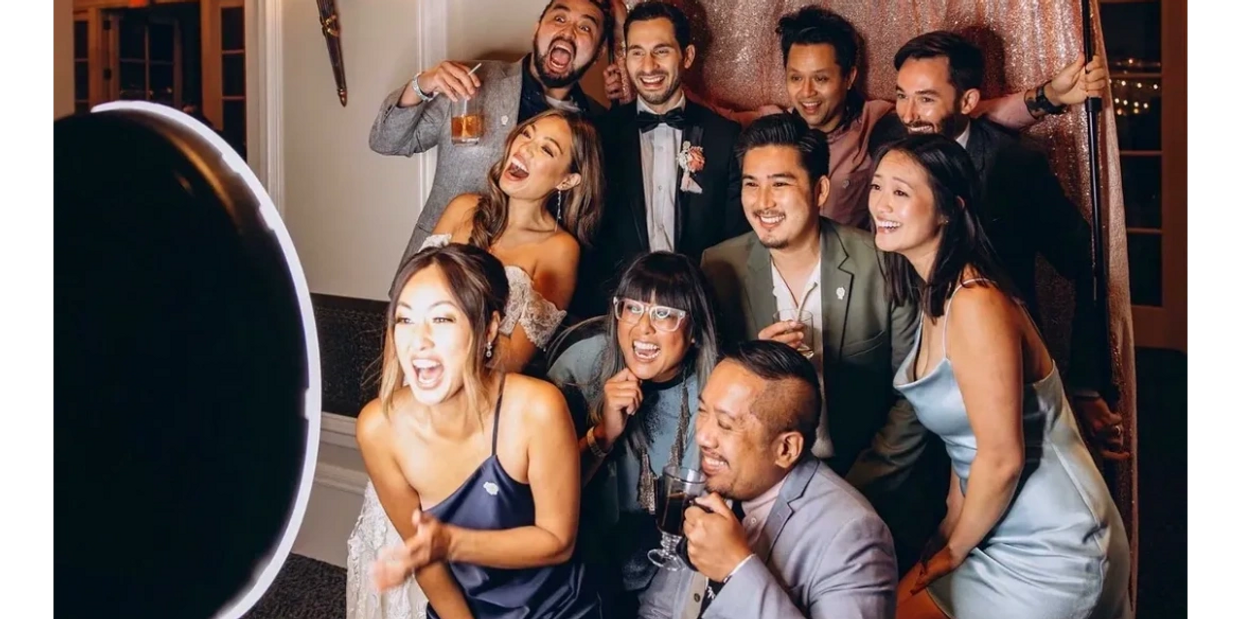 A lively group of friends joyfully posing for a photo at a celebration.