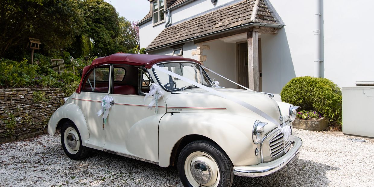 Classic white vintage car decorated for a wedding.