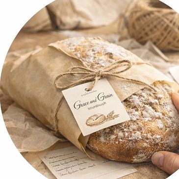 Rustic basket with fresh sourdough bread, wheat stalks, and a notebook with pencil.