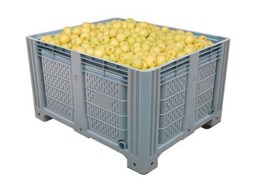 A large crate filled with yellow apples.