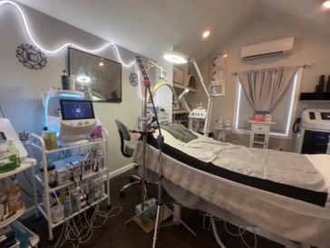 Modern spa treatment room with advanced skincare equipment and cozy ambiance.
