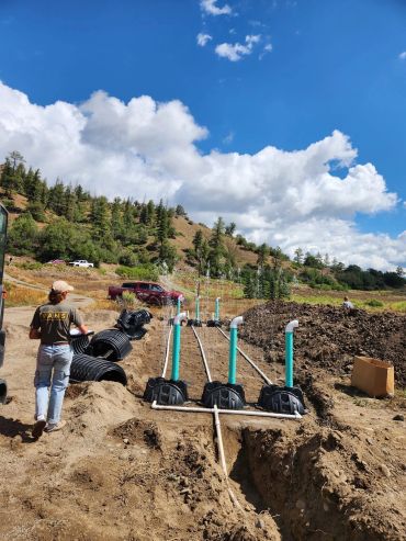 Outdoor irrigation system with multiple sprinklers in a rural area.