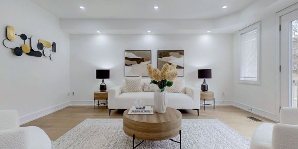 Modern living room with neutral tones and wooden accents.