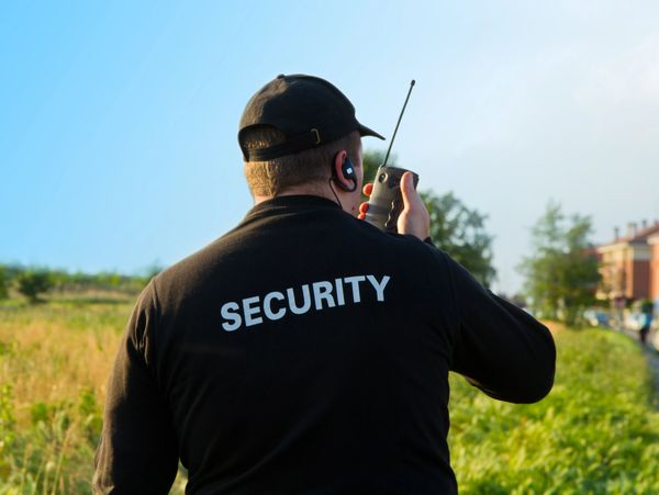 Security guard with a handheld transceiver, PMR